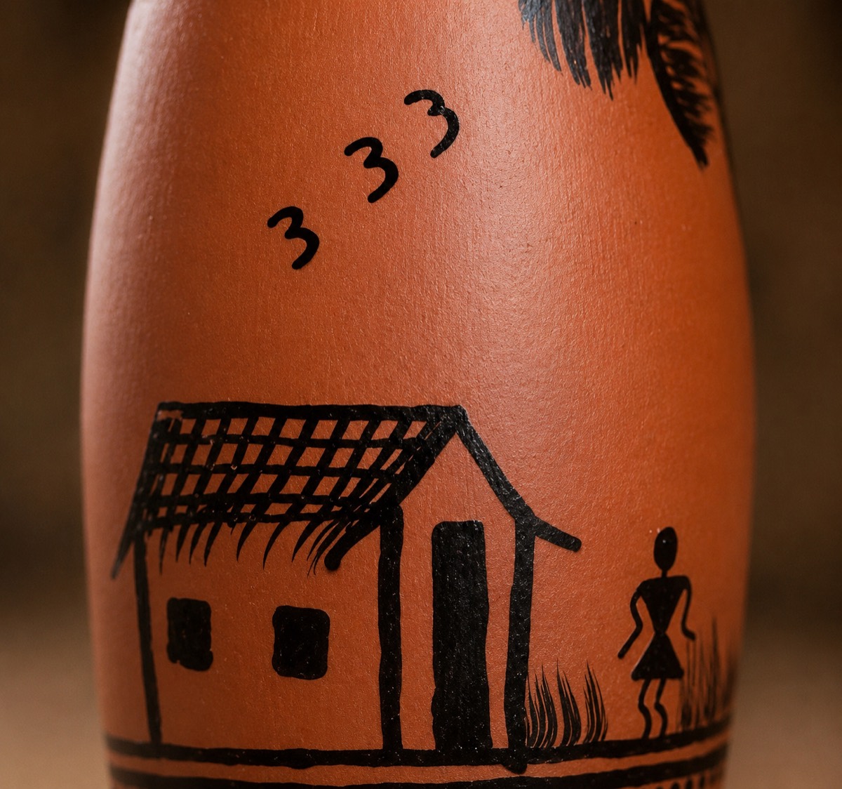 Close-up of a Warli art hand-painted clay water bottle